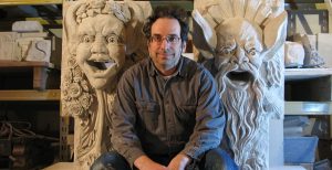 Sculptor Walter S Arnold with two of his gargoyles