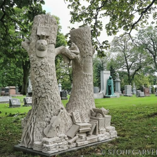This large double treestump tombestone, with details telling of the couples lives and passions, is installed at Bohemian National Cemetery in Chicago.